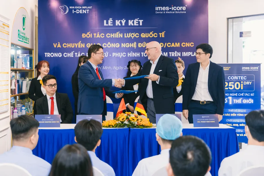 Representatives from both parties signing the agreement